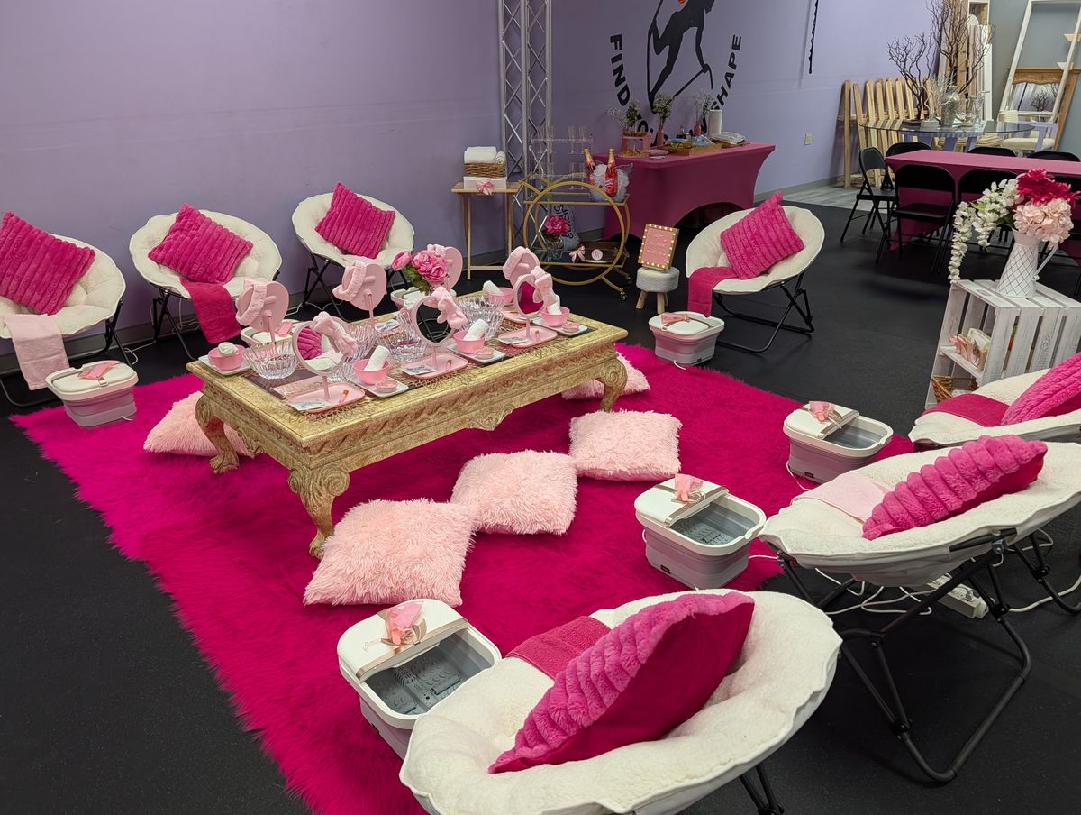 Full spa lounge with chairs, foot spas, pillows and a gold table